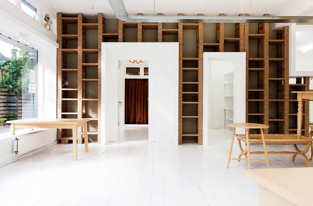 a room with shelves and tables