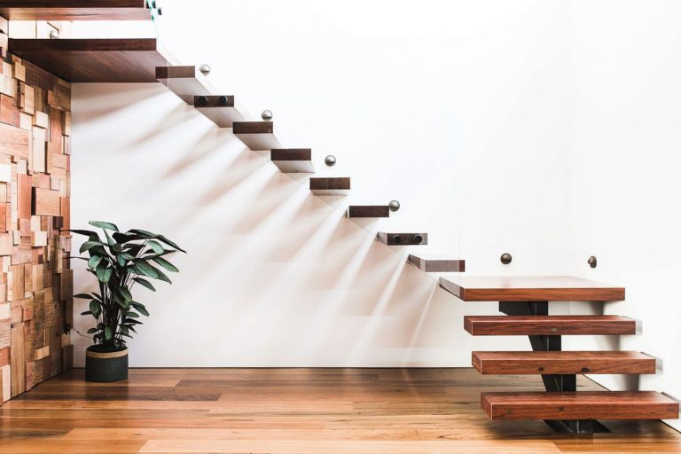 a set of stairs in a room with a plant