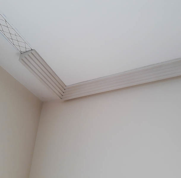 a white ceiling with a mesh on the corner