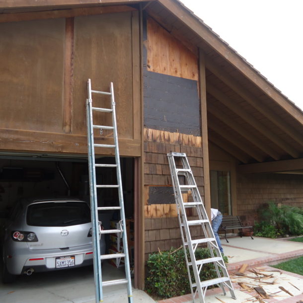 a ladders leaning against a garage door