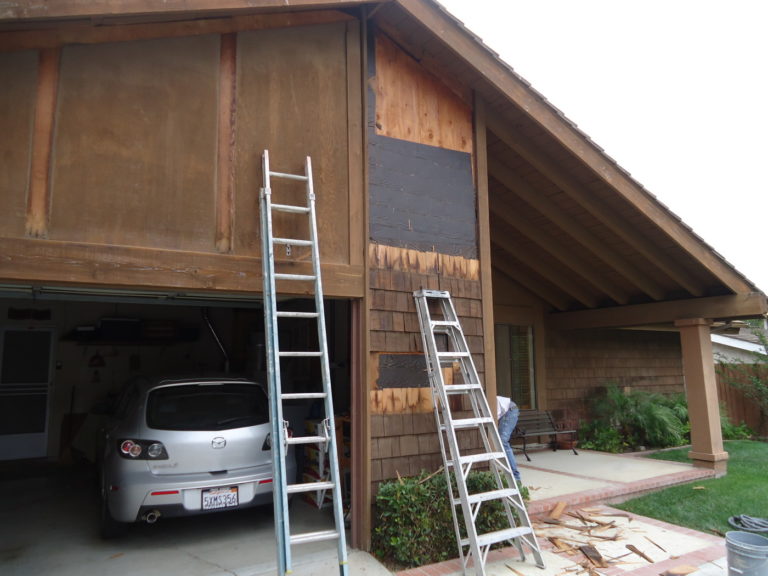 a ladders leaning against a garage door