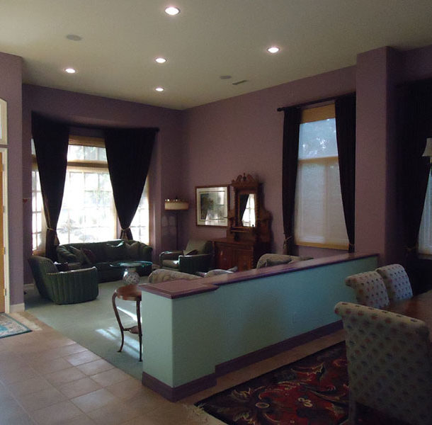 a living room with purple walls and a couch
