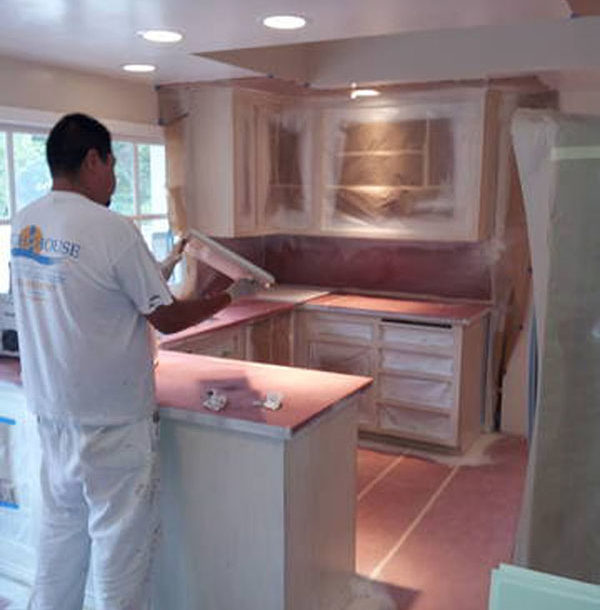 a person painting a kitchen
