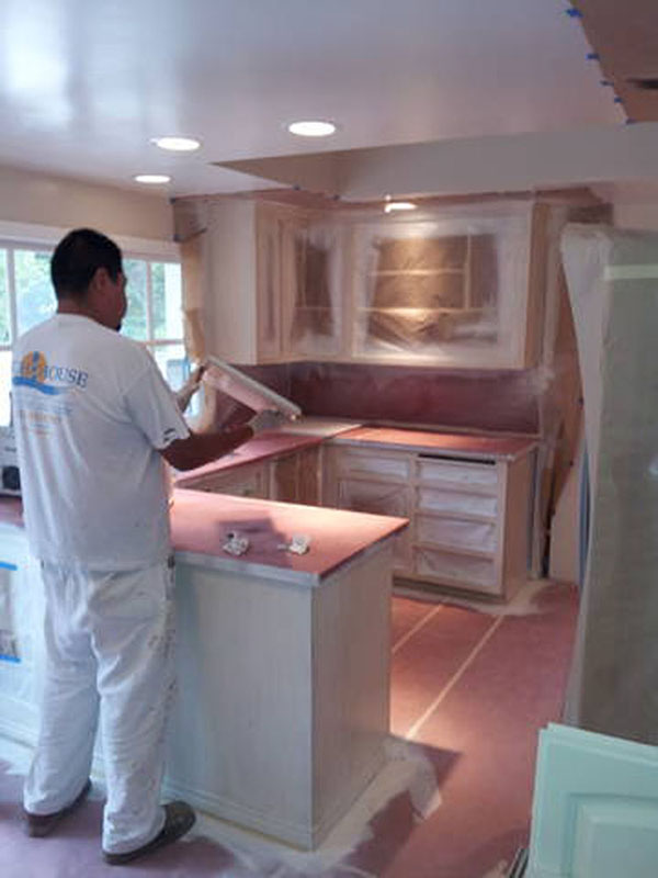 a person painting a kitchen